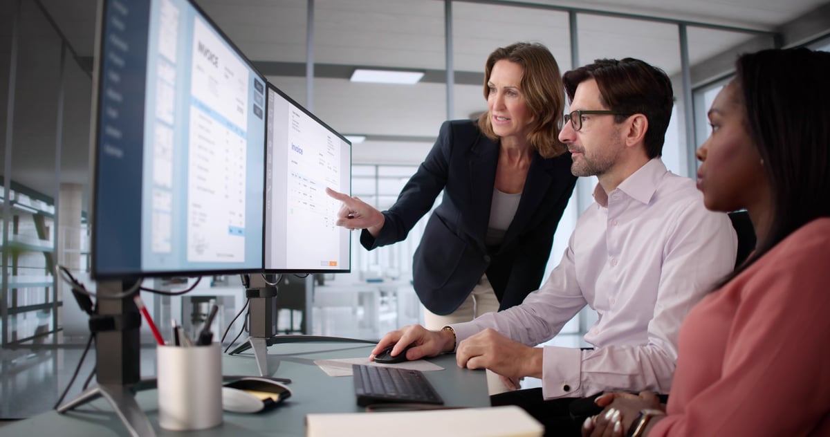 Office manager and accountant analyzing financial statements on computer